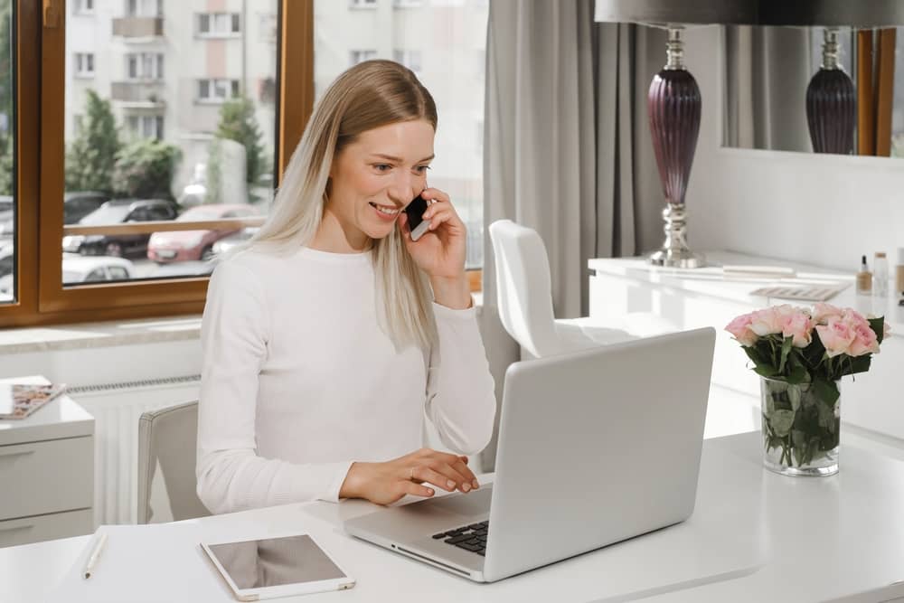 Successful medical spa owner on phone consultation while managing practice operations from modern clinic office