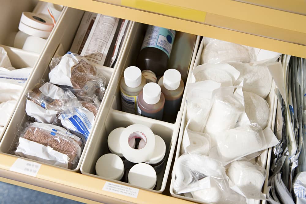 Organized medical emergency kit drawer with hyaluronidase supplies gauze and safety materials for managing dermal filler complications