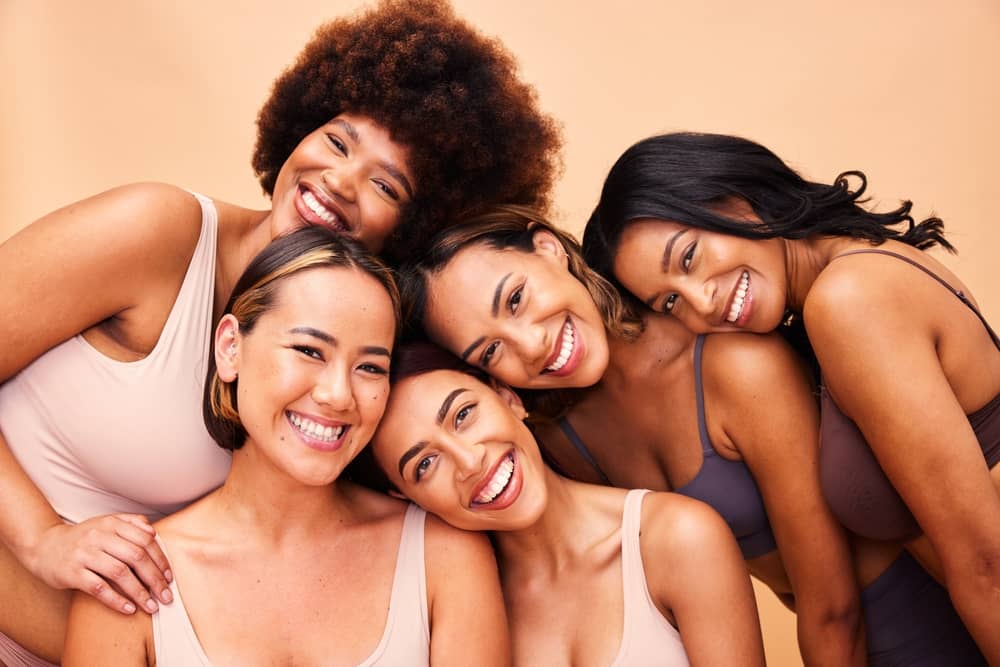 Happy diverse group of women with glowing skin showcasing successful medical spa aesthetic treatment results