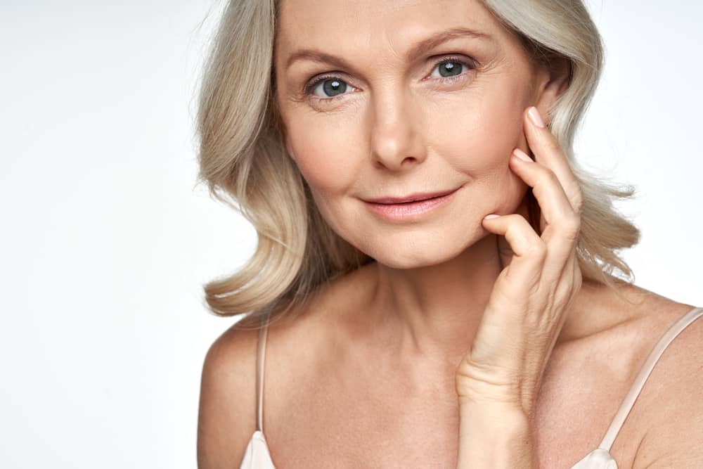 Confident mature woman with natural jawline definition achieved through safe non-surgical contouring demonstrating successful aesthetic outcomes