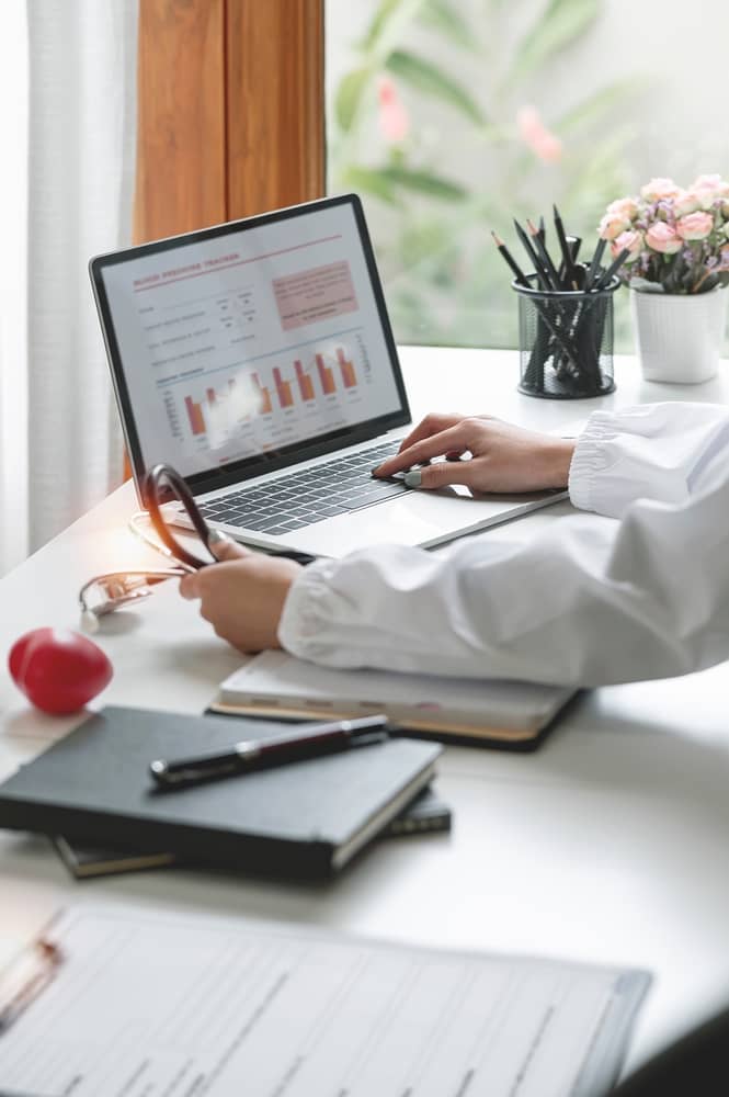Plastic surgery practice analytics dashboard showing website conversion statistics and patient consultation metrics on laptop